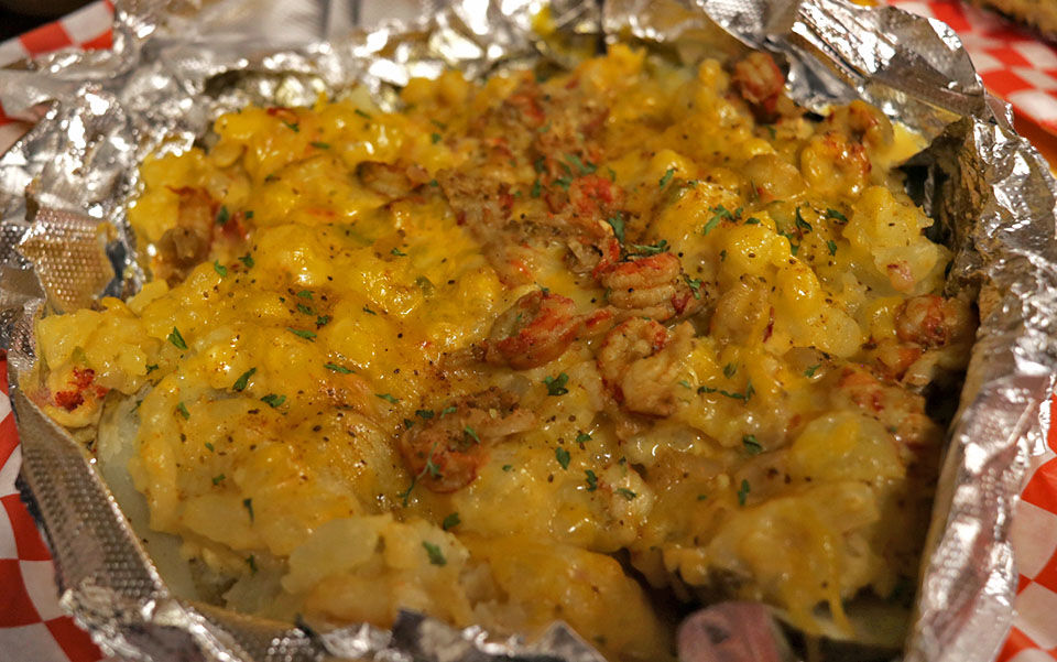 Seafood loaded potato featured at Reo's Louisiana Kitchen
